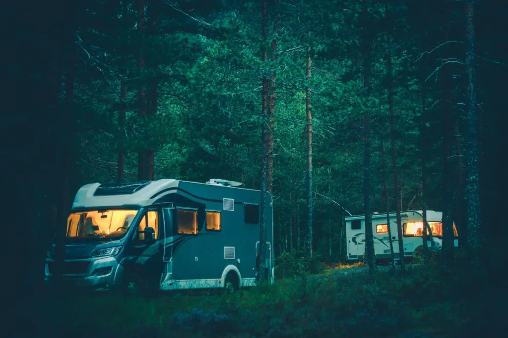 Two RVs at a campground deep in the woods